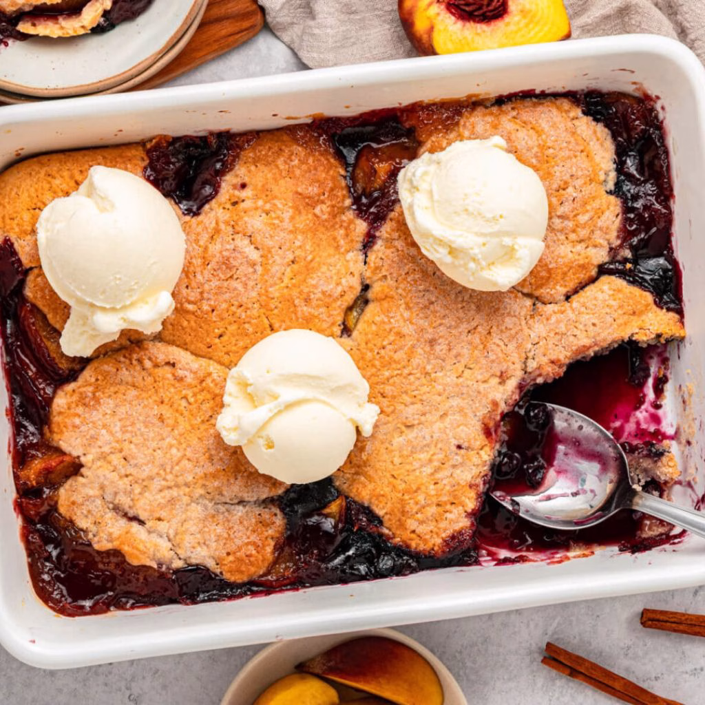 Baked Peaches With Blueberry Sauce and Vanilla Ice Cream